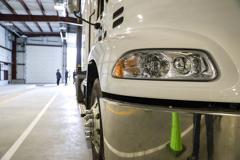 close up of white semi truck at wheel level.